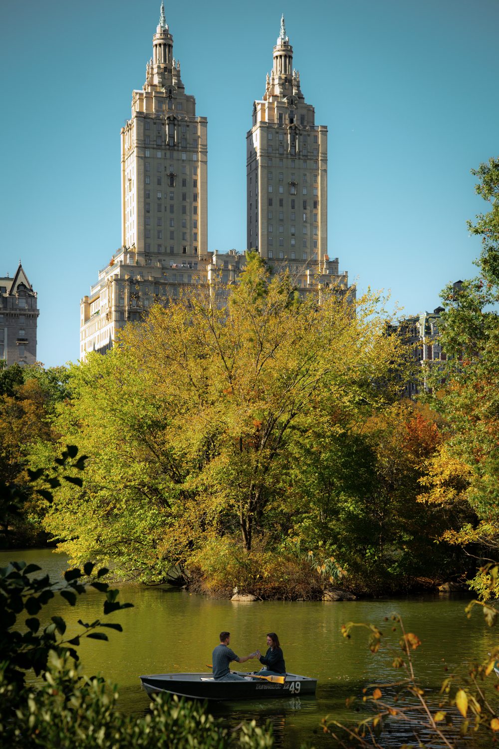 A couple in a rowboat on the Lake in Central Park in fall